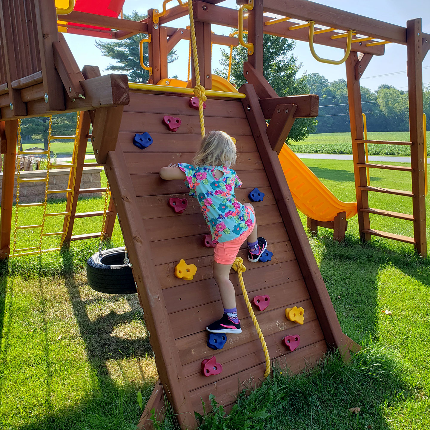 The Calvary United Methodist Church Community Playground with a child on the climbing wall