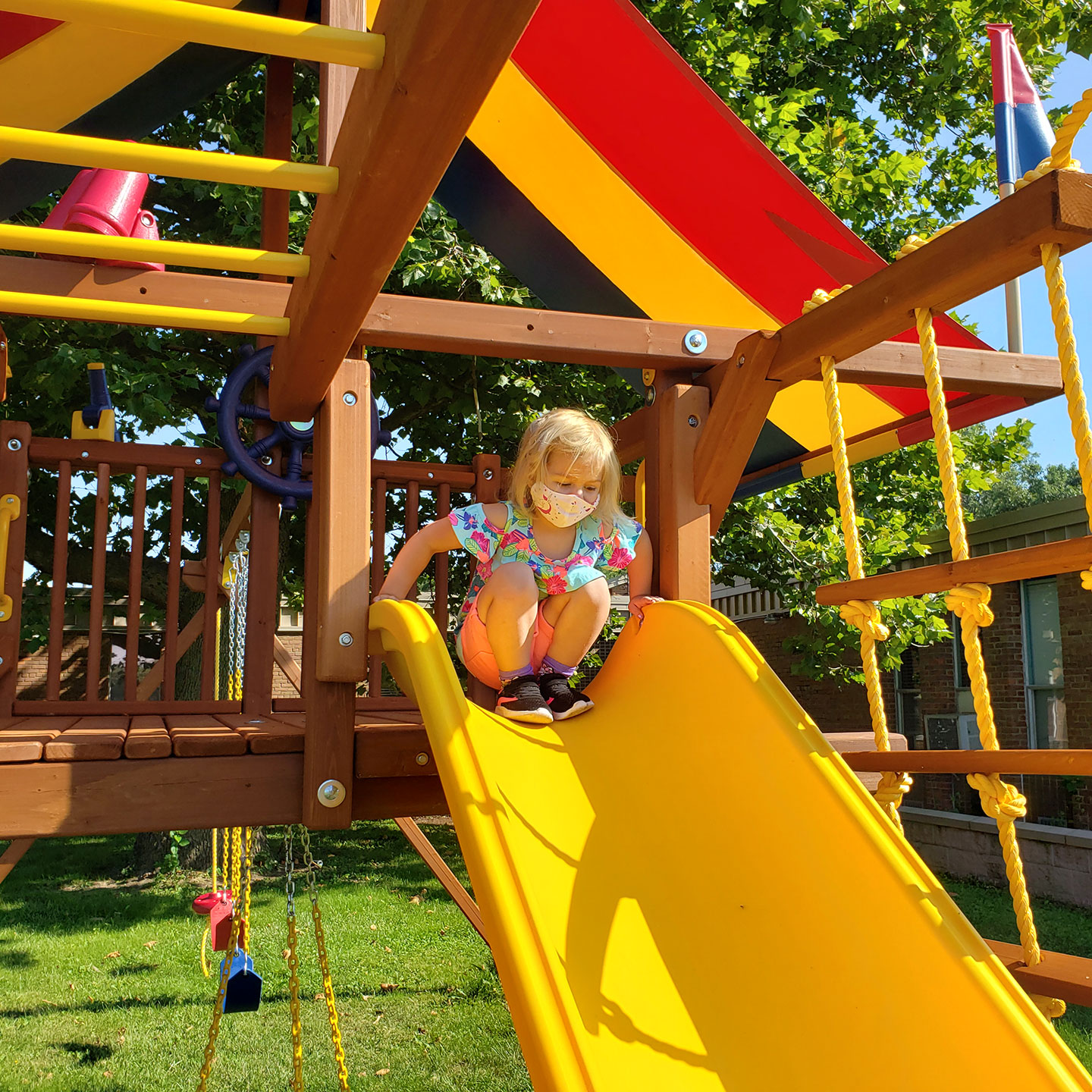 The Calvary United Methodist Church Community Playground with a child preparing to use the slide
